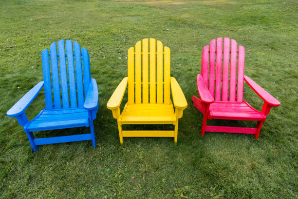 Old striped folding chairs in a rural garden, Russia