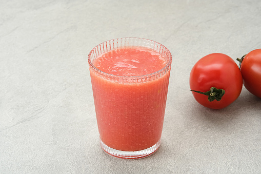 Tomato Juice in glass, cold pressed juice with fresh fruit