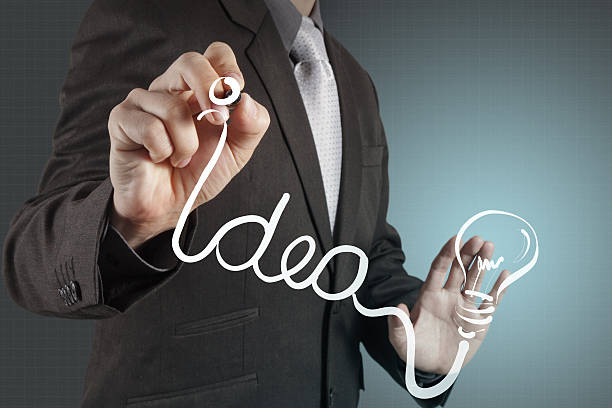istock businessman with a pen drawing light bulb 176427323