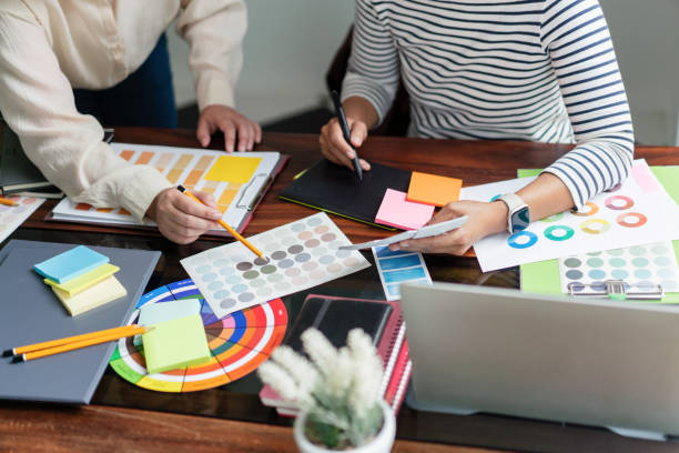 istock Two creative graphic designers discuss about colors swatch to designing project and draw on tablet 1764274133