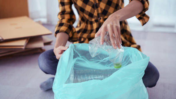 istock Women squeeze plastic bottle and putting in plastic bag for recycling and conservation environment 1764294667