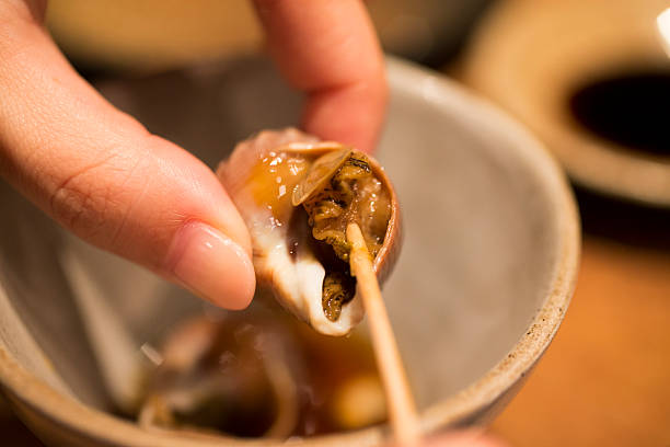 salted lupins on white plate and snails with glass of beer