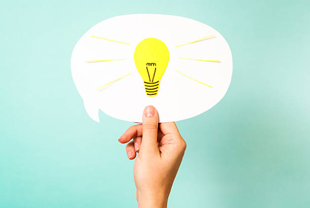 istock Hand showing white bubble. Yellow lightbulb. Smart think reinvent concept 176430210