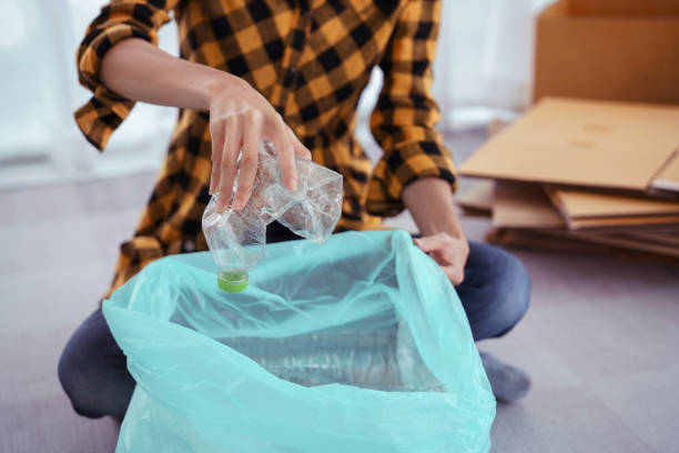 istock Women squeeze plastic bottle and putting in plastic bag for recycling and conservation environment 1764313554