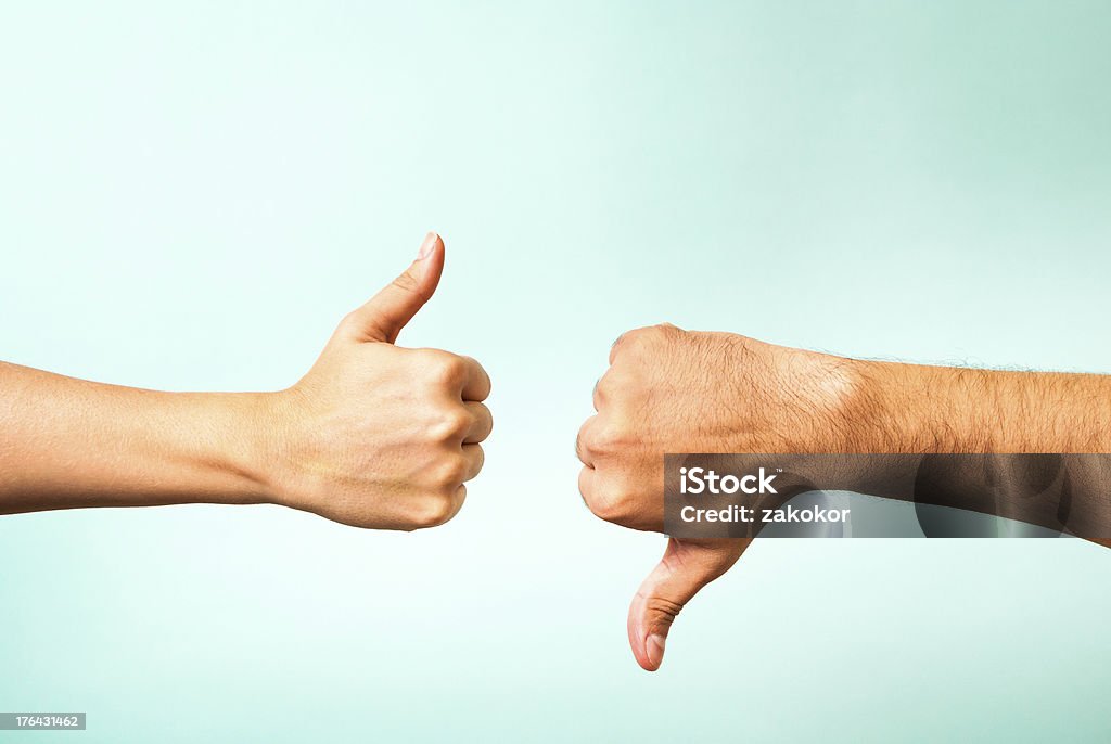 Two hands signalling thumbs up and thumbs down Hands are making indecision signals Yes - Single Word Stock Photo