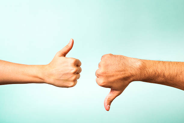 Two hands signalling thumbs up and thumbs down Hands are making indecision signals rudeness stock pictures, royalty-free photos & images