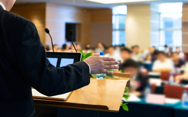 istock Business man making a speech in front of big audience 1764314726