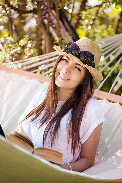 istock young woman reading in hammock 176431514