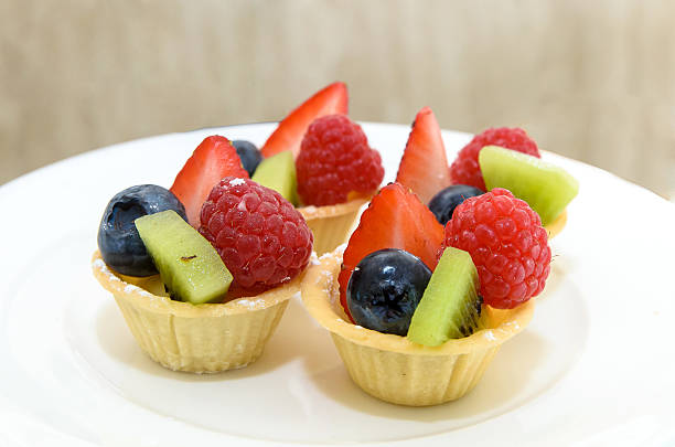 istock Fruit Tart with berries and kiwi on white disc 176431548