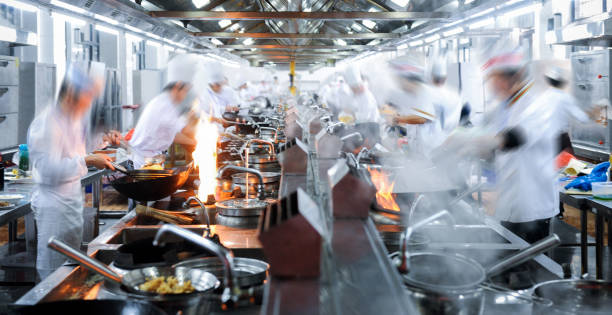 Motion chefs working in Chinese restaurant kitchen Motion chefs working in Chinese restaurant kitchen number of people stock pictures, royalty-free photos & images