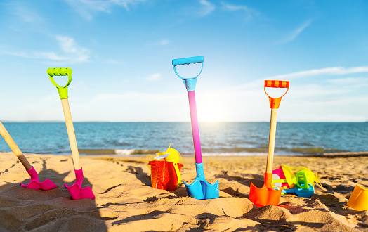 Group of children's beach toys on sunny day