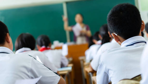 istock Rear view of students studying in classroom 1764320086