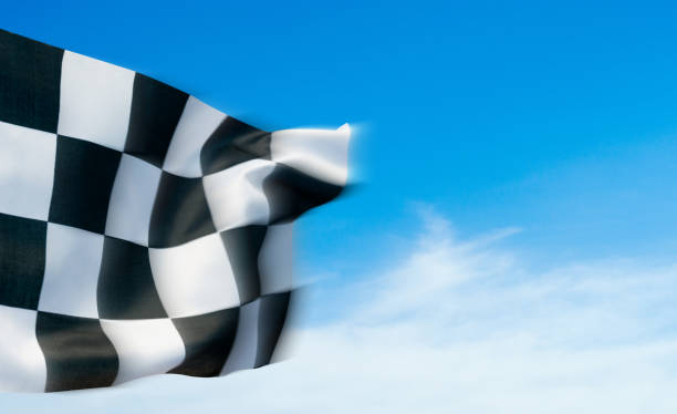 istock Closeup of checkered flag against blue sky 1764321692