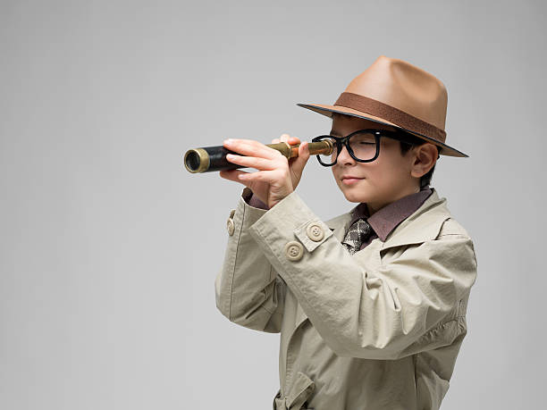 istock Little detective in trench coat holding hand held telescope 176432810