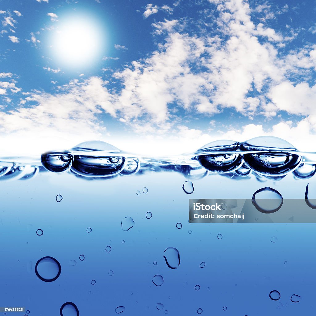 Water wave on sky background Water wave and water bubble on sky background. The water bubble raises to the surface Blue Stock Photo