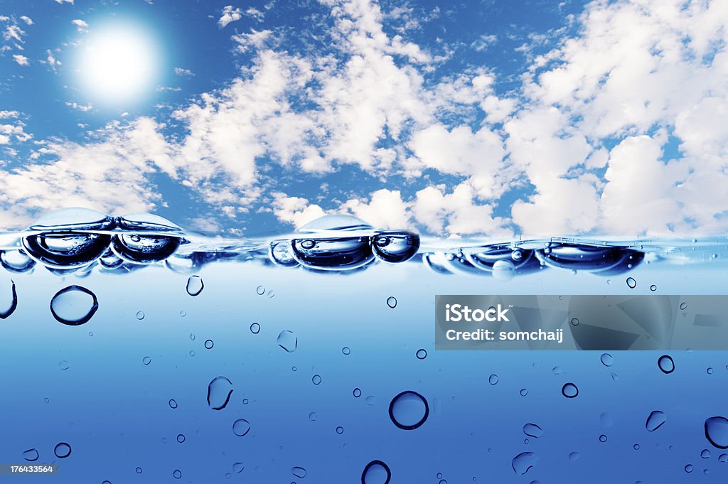 Water wave on sky background Water wave and water bubble on sky background. The water bubble raises to the surface Blue Stock Photo