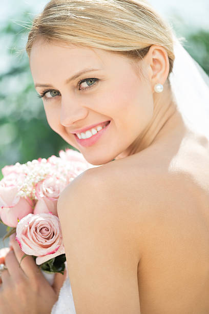 istock Bride In Backless Wedding Dress Holding Flower Bouquet 176436321