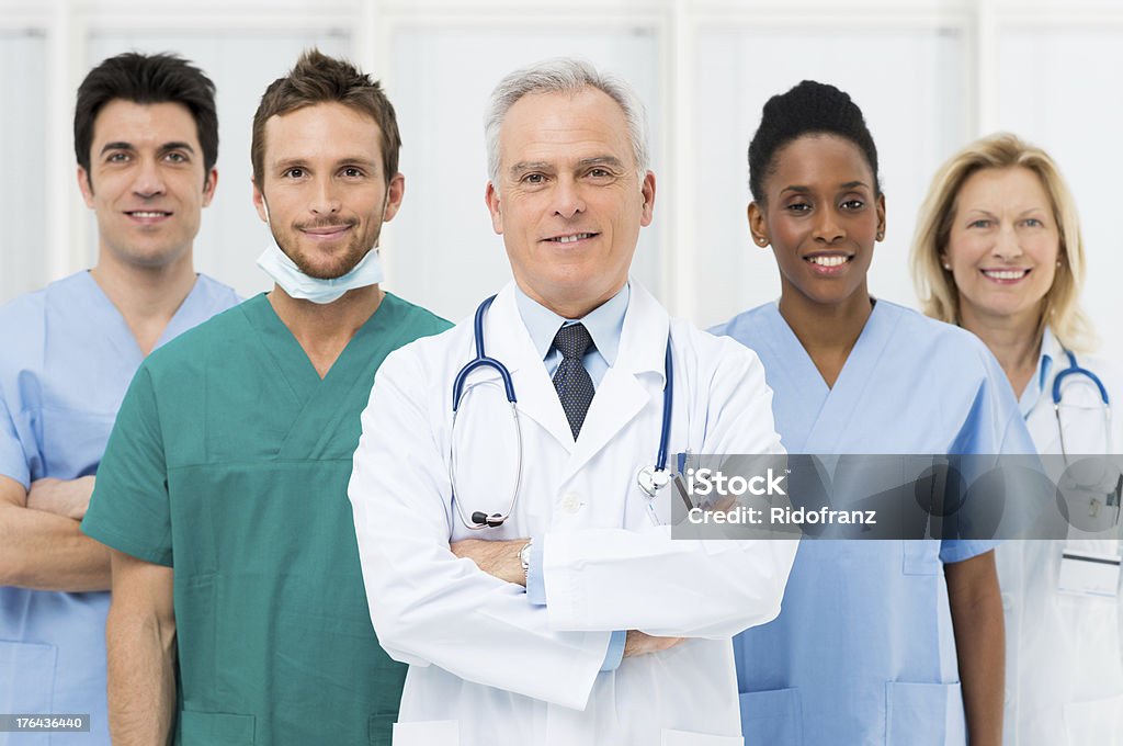 Happy Team Of Doctors Smiling team of doctors and nurses at hospital Group Of People Stock Photo