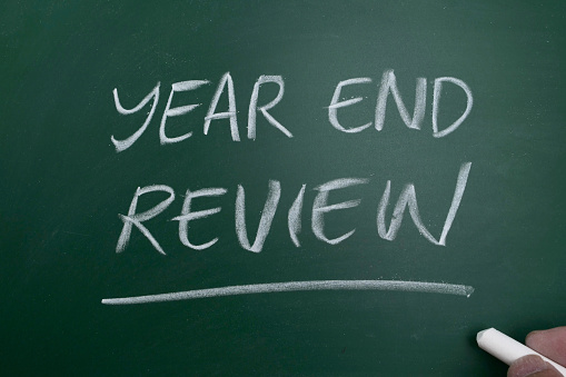 Year end review in life; business. chalkboard  writing and preparing for new year resolutions