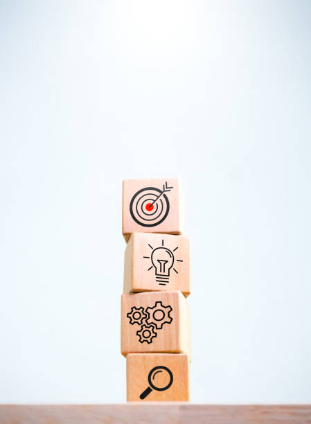 istock Business strategy and action plan icon on four wooden cube blocks stack isolated on white background, vertical style. Objective, goal and success, marketing and management process, startup concepts. 1764380351