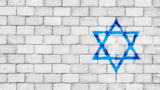 A very light grey white colored brick wall with rectangular blocks, textured grungy backgrounds with vibrant contrasting Israeli flag painted over dull faint neutral backdrop. There is no people and copy space. It is a rustic modern backdrop template.