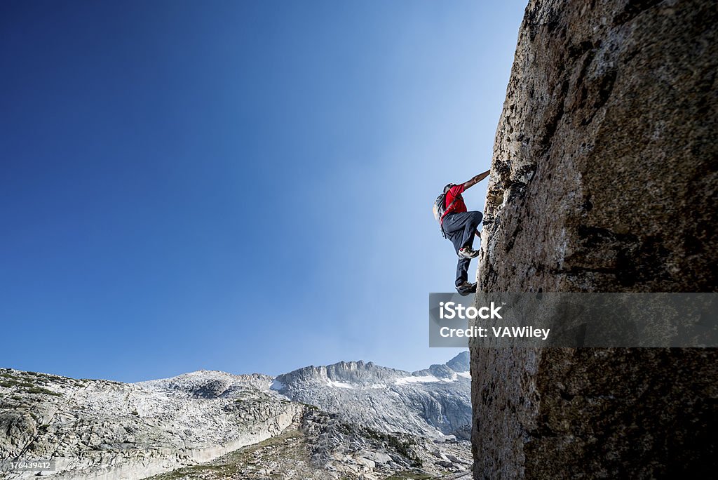 climbing up Mountain man climbing a rock  Achievement Stock Photo