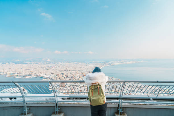 Woman tourist Visiting in Hakodate, Traveler in Sweater sightseeing view from Hakodate mountain with Snow in winter. landmark and popular for attractions in Hokkaido, Japan.Travel and Vacation concept Woman tourist Visiting in Hakodate, Traveler in Sweater sightseeing view from Hakodate mountain with Snow in winter. landmark and popular for attractions in Hokkaido, Japan.Travel and Vacation concept motomachi kobe stock pictures, royalty-free photos & images