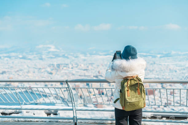 Woman tourist Visiting in Hakodate, Traveler in Sweater sightseeing view from Hakodate mountain with Snow in winter. landmark and popular for attractions in Hokkaido, Japan.Travel and Vacation concept Woman tourist Visiting in Hakodate, Traveler in Sweater sightseeing view from Hakodate mountain with Snow in winter. landmark and popular for attractions in Hokkaido, Japan.Travel and Vacation concept motomachi kobe stock pictures, royalty-free photos & images