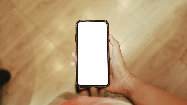 istock Women's hands holding cell telephone blank copy space screen. smartphone with blank white screen isolated on white background . smart phone with technology concept 1764428962
