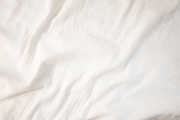 istock Fabric backdrop White linen canvas crumpled natural cotton fabric Natural handmade linen top view background Organic Eco textiles White Fabric texture 1764429032