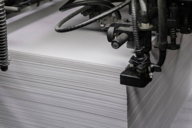 istock Printed sheets of paper are served in the printing press offset printing 1764444602