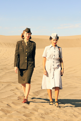 Two military women during World War 2: an officer and a nurse. Authentic WW2 nurse uniform and props. Vintage styling. More vintage military photos.