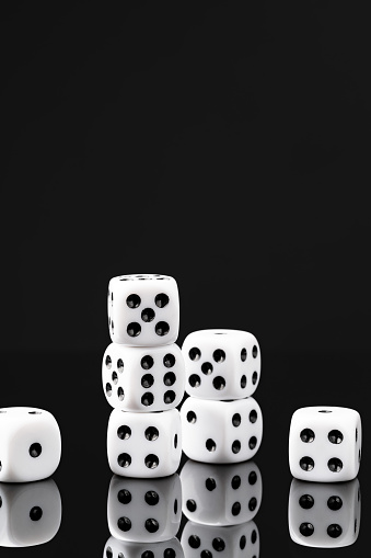 White dice on black background studio shot close up