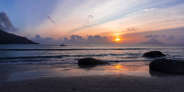 istock Coastal rocks on the beach at sunset. Mahe island, Seychelles 1764478428