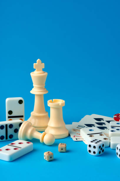 istock Items for playing chess, poker and domino on blue background studio shot 1764478449