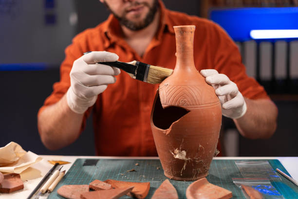 istock Archeologist working late night in office recovering ancient pottery object 1764500983