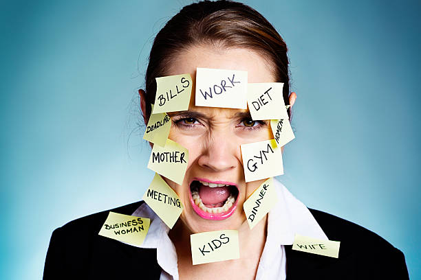 istock Woman covered in  task reminders yells angrily 176450319