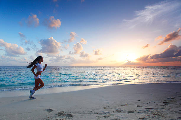 istock Woman running on beach 176450717