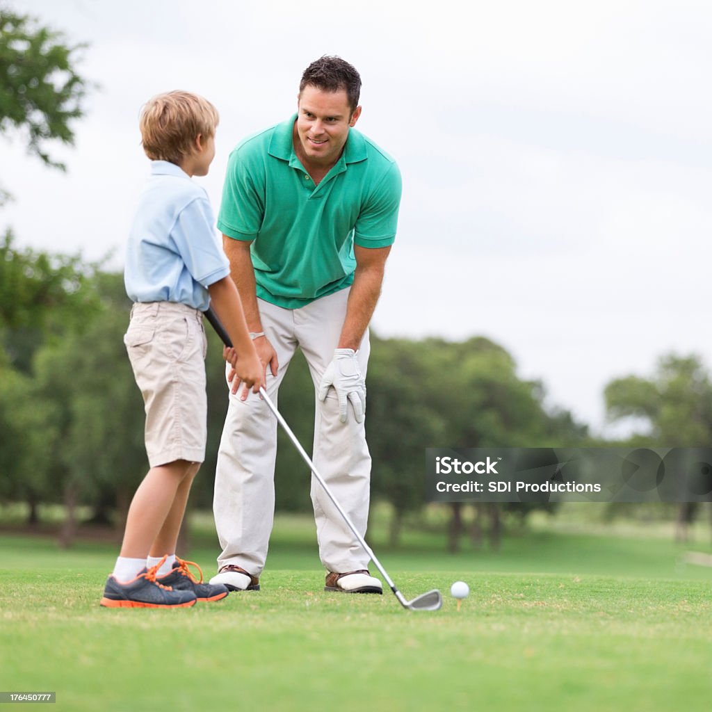 Father teaching his young son to golf Father teaching his young son to golf. Golf Stock Photo