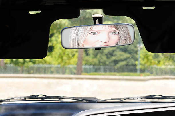 istock Pensive woman reflected in rear view mirror 176450851