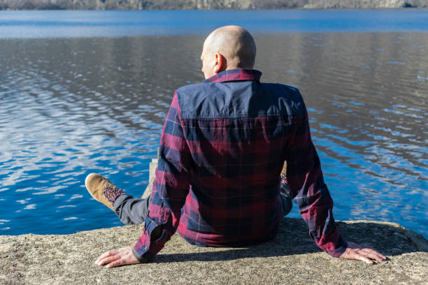 istock Man on the shore of a lake. 1764512937