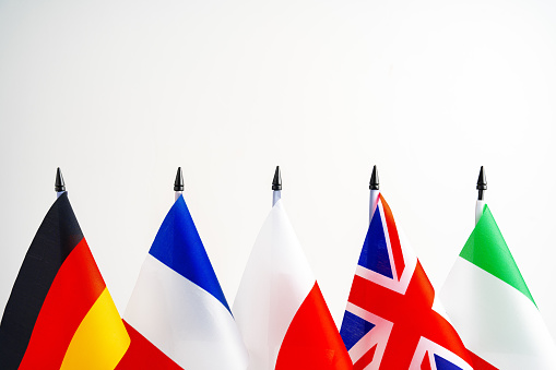 Lots of small national flags on table close up