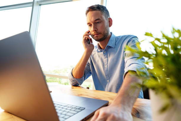 istock Handsome businessman speaking on the phone in office 1764521709