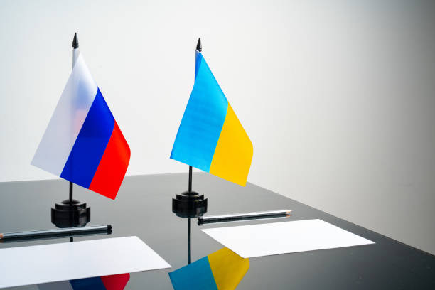 istock Russia and Ukraine flags on negotiation table 1764525542