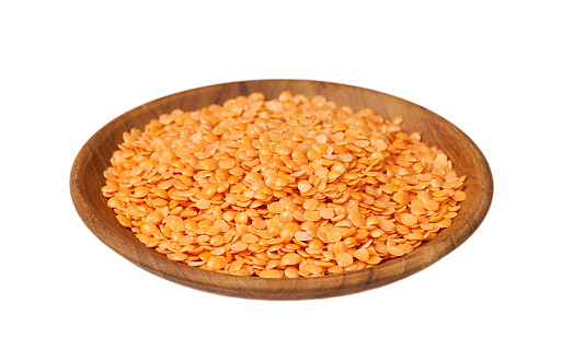 red Lentil seed isolated on white background. pile of red Lentil seed isolated. heap of red Lentil seed in wood bowl isolated