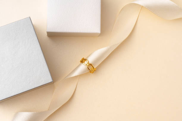 istock Golden jewelry ring on ribbon studio shot 1764544843