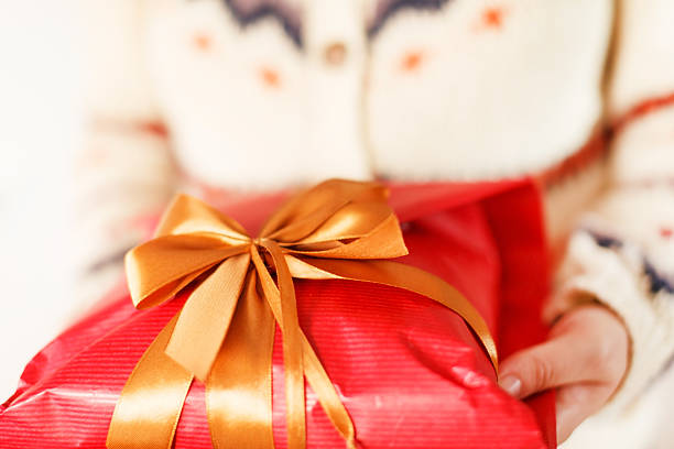 istock woman holding presents 176455403