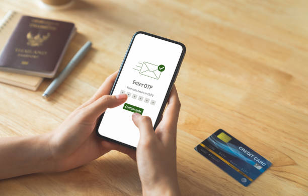 istock Hand using smartphone and mobile OTP secure verification on send to email with enter password for login banking account on on desk. 1764557397