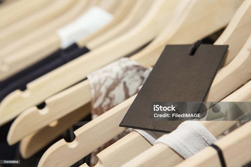 Clothes On a Rack Clothes hang on a shelf in a designer clothes store in Melbourne, Australia Melbourne - Australia Stock Photo