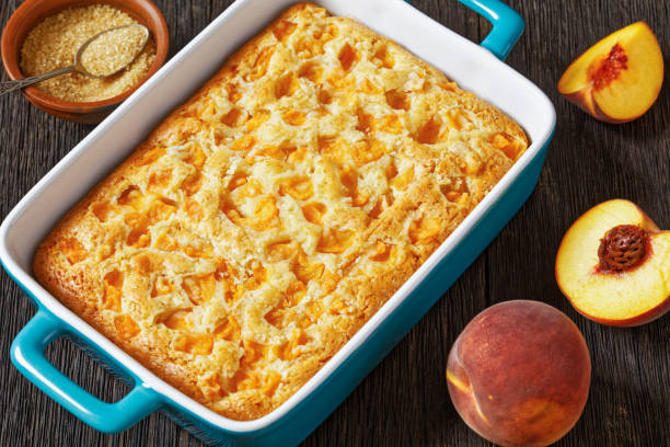 istock peach cake in baking dish on dark wooden table 1764561133